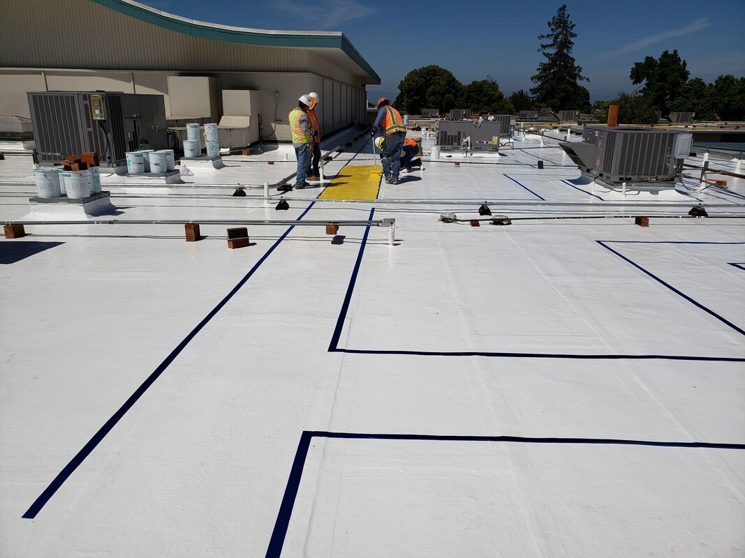 Roofing restoration at Russell. Currently in process is a non-skid safety roof walkway. (The lines of tape are a guide, marking where material is being applied for walkways).